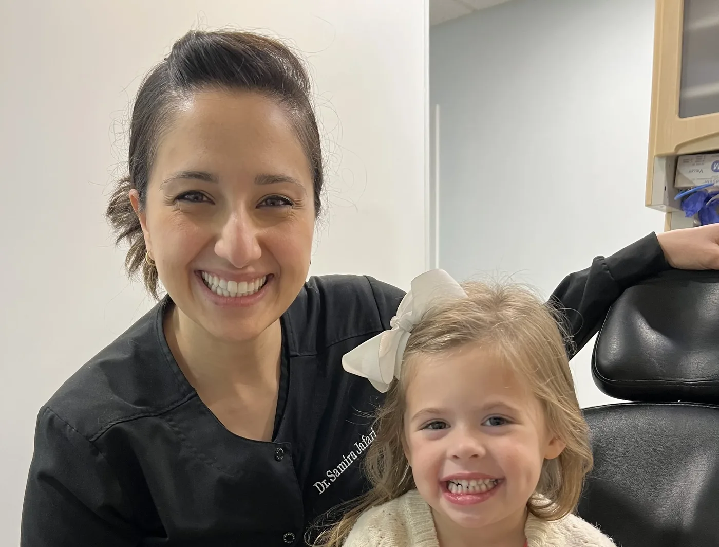 Dr. Samira Jafari smiling with a young patient at Integrative Family Dentistry in Roswell, GA
