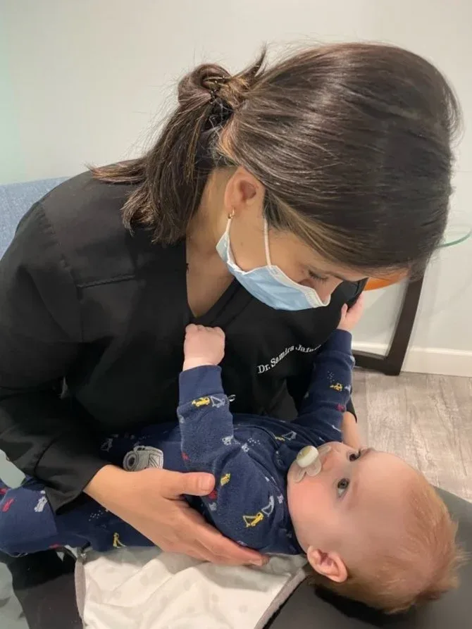 Dr. Jafari examining an infant