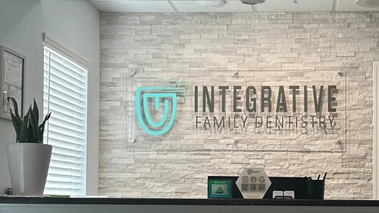 Reception area with the Integrative Family Dentistry logo wall in Roswell, GA